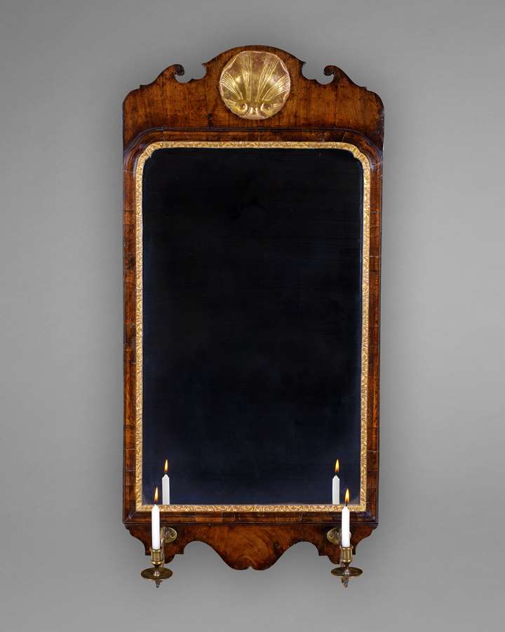 A GEORGE I WALNUT AND GILDED MIRROR